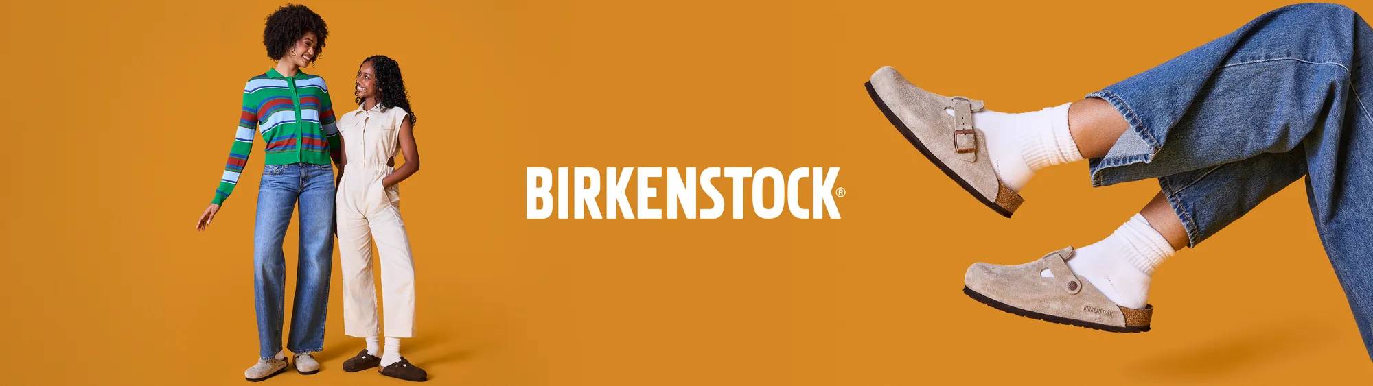 Two women wearing Birkenstock clogs against an orange background