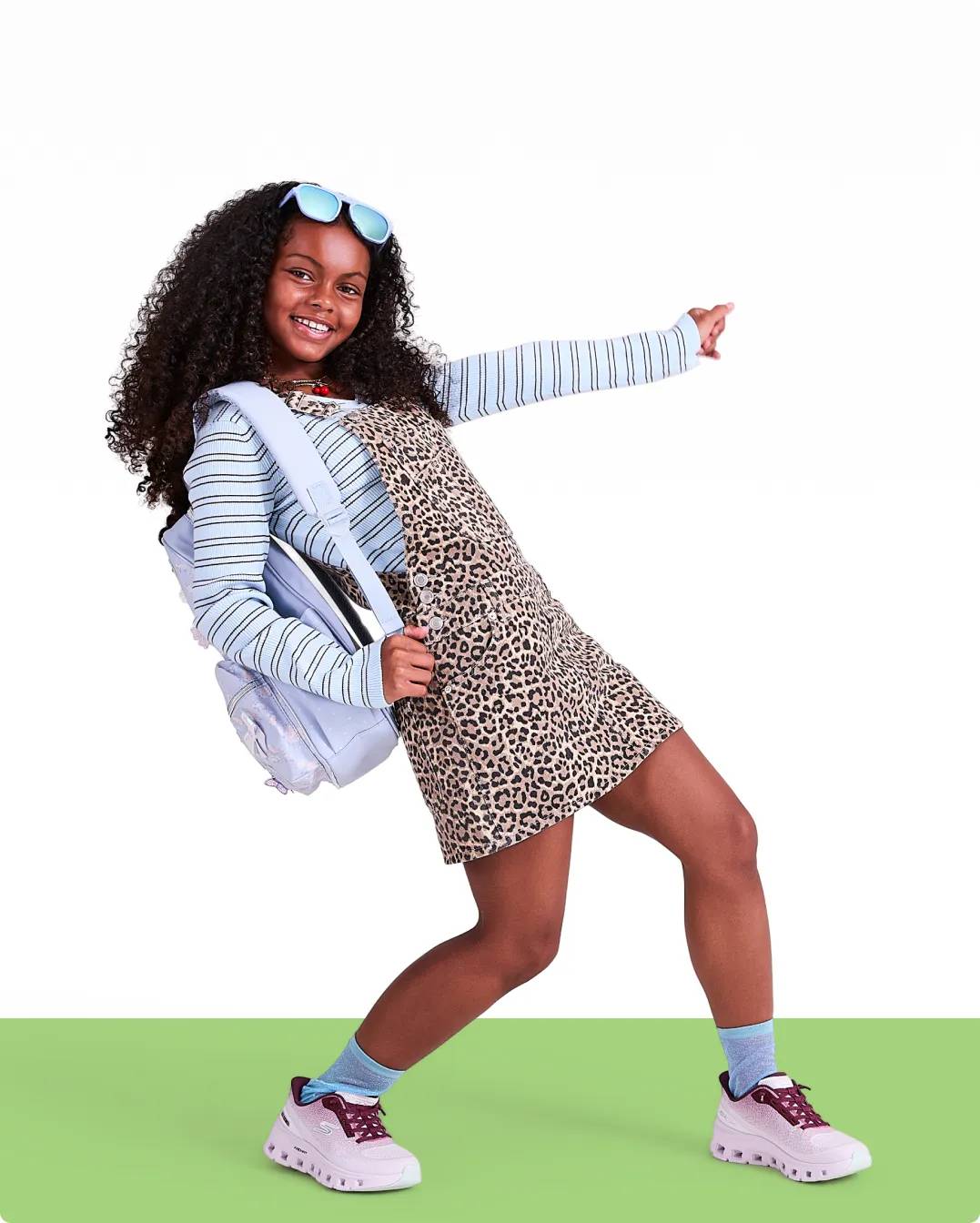 a kid with back to school shoes and backpack