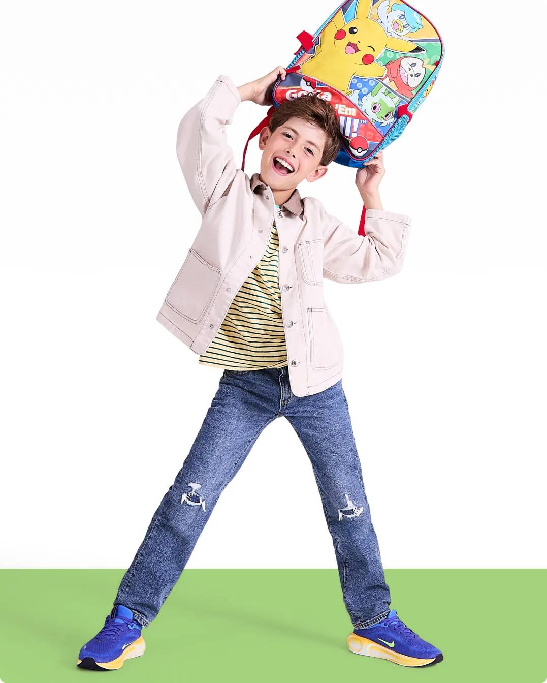 a boy holding a backpack for back to school
