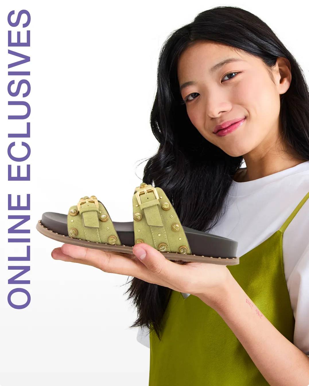 Woman holding up a green sandal in the palm of her hand