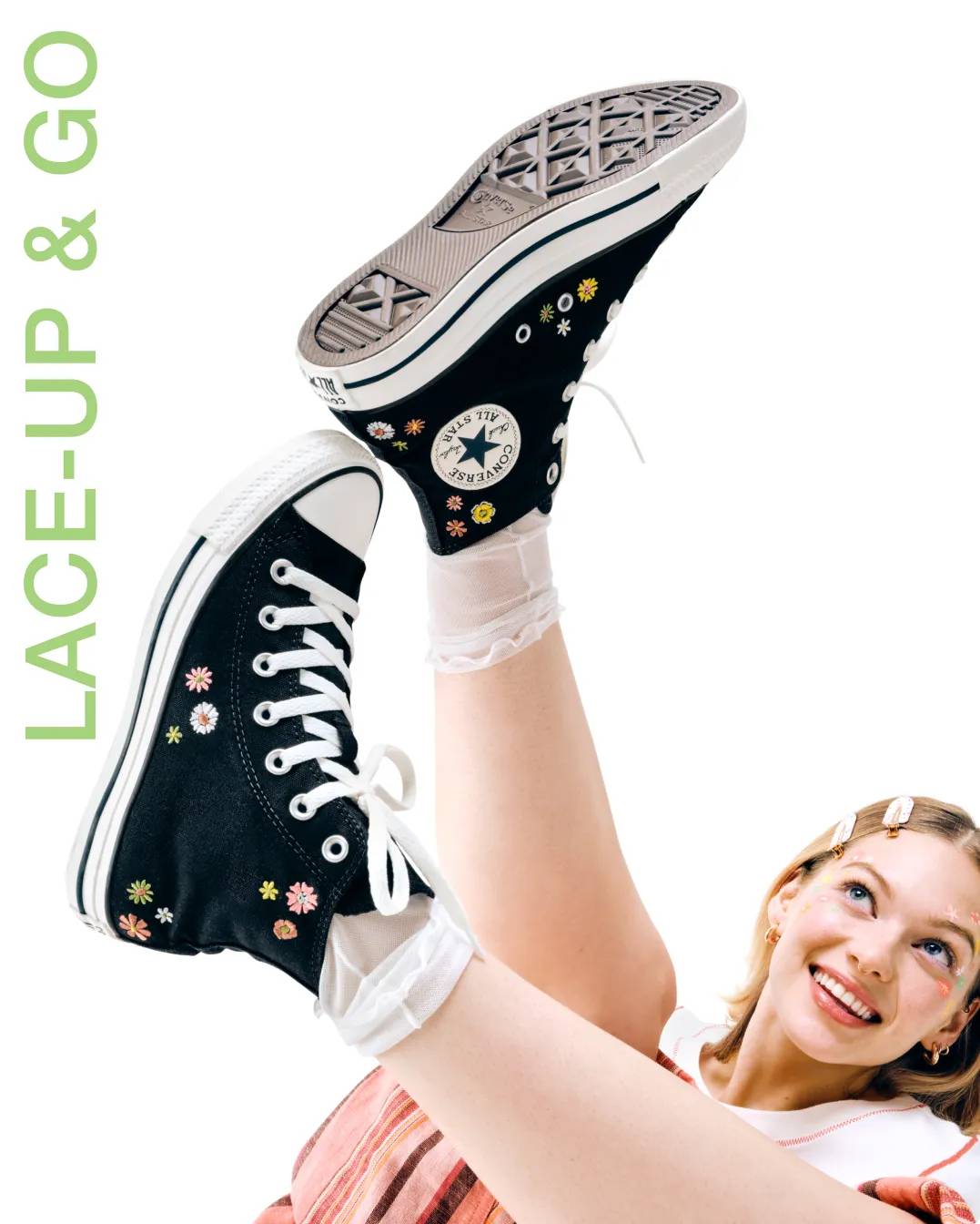 Woman wearing black Converse shoes