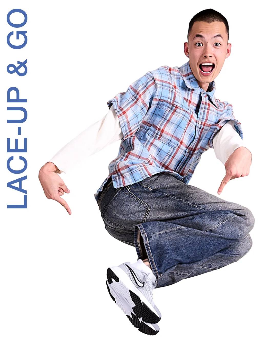 Man mid-jump pointing to his white Nike sneakers