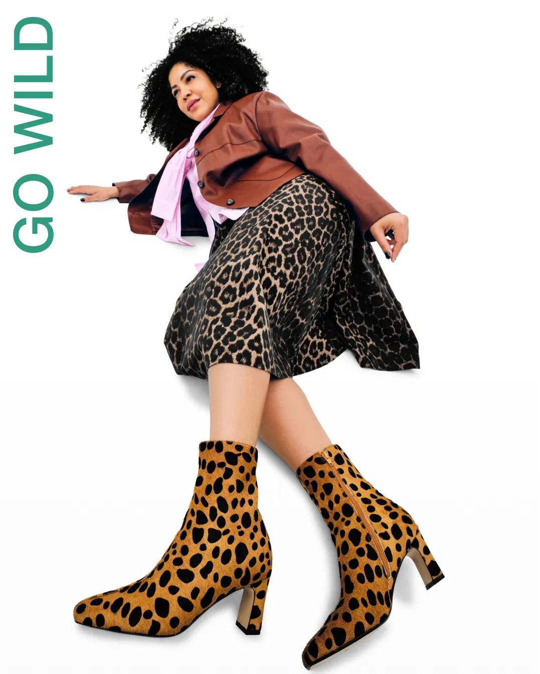 Woman wearing animal print ankle booties and skirt