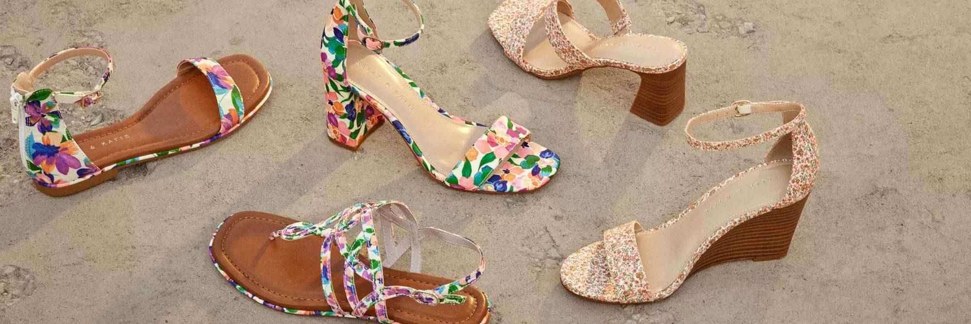 Featuring an assortment of shoes on the beach.
