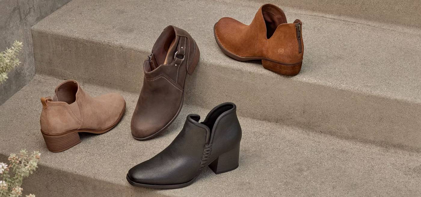 An assortment of ankle boots sitting on stairs