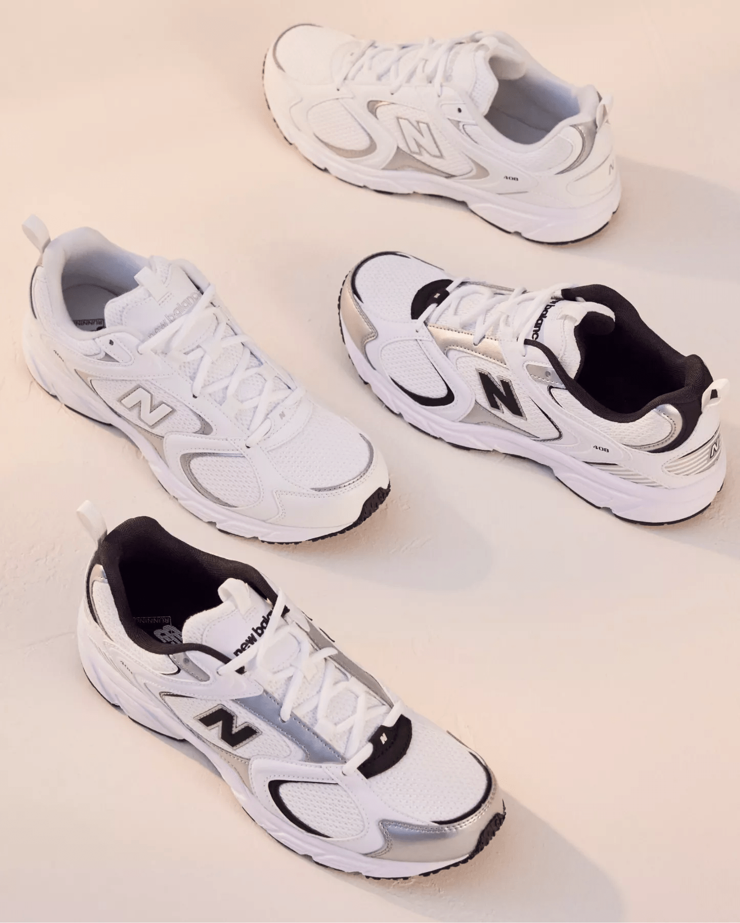 Various white new balance sneakers on a beige background