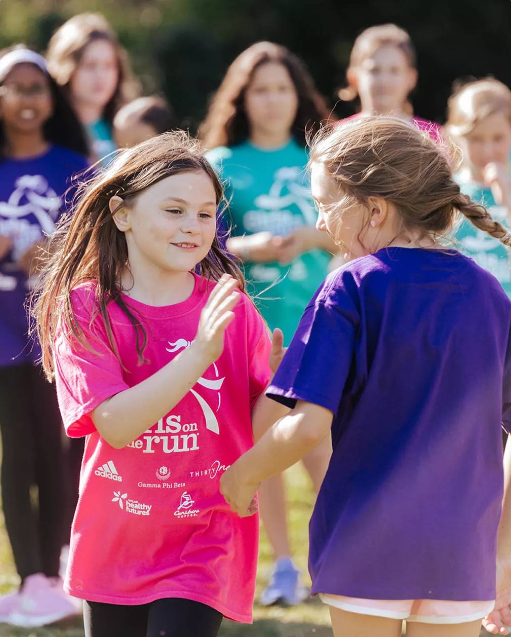 Featuring two girls about to high-five one another.