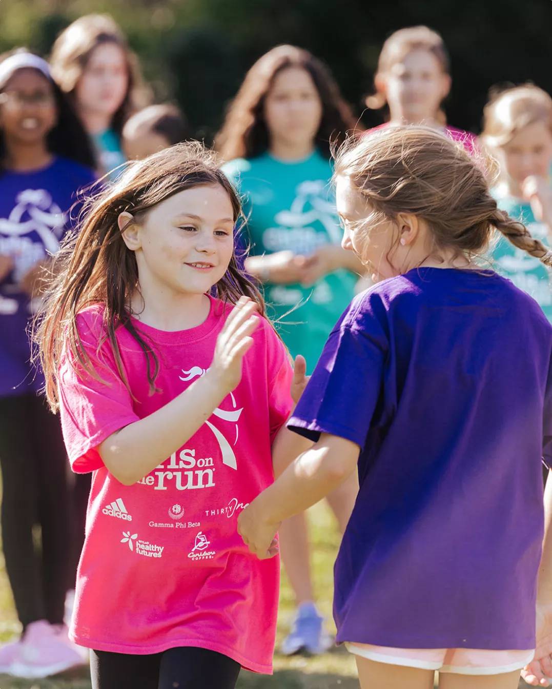 Featuring two girls about to high-five one another.