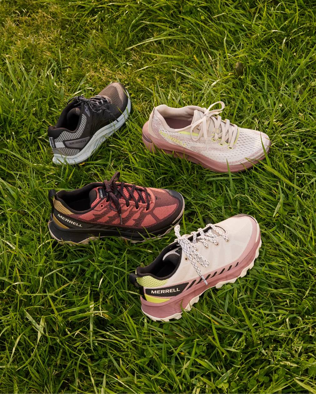 Four women's walking shoes on a grass background