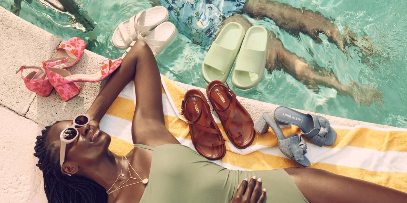 Women Laying by a pool surrounded by this season's best summer shoe trends.