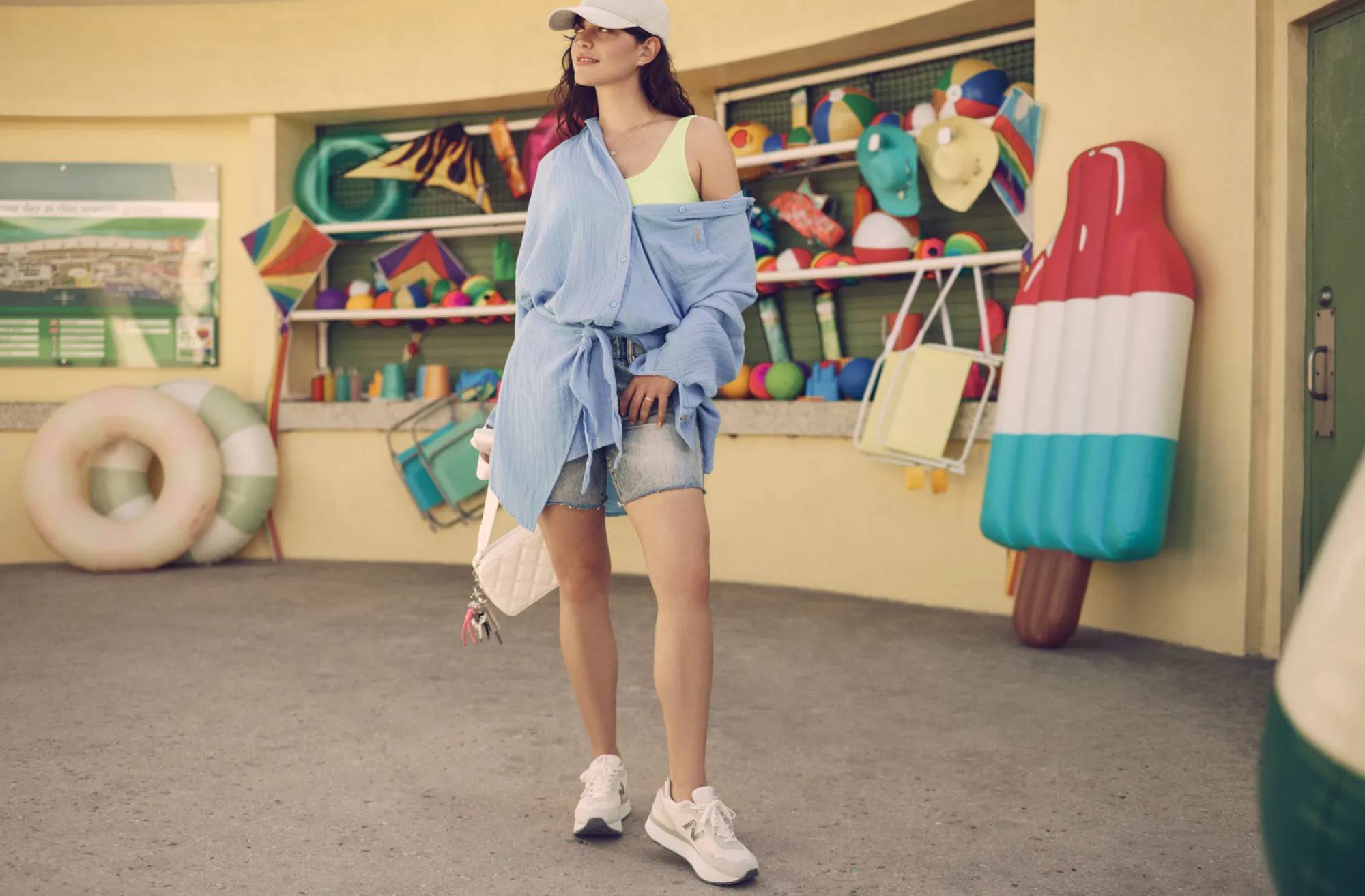 Women in a casual outfit wearing chunky sneakers by New Balance.