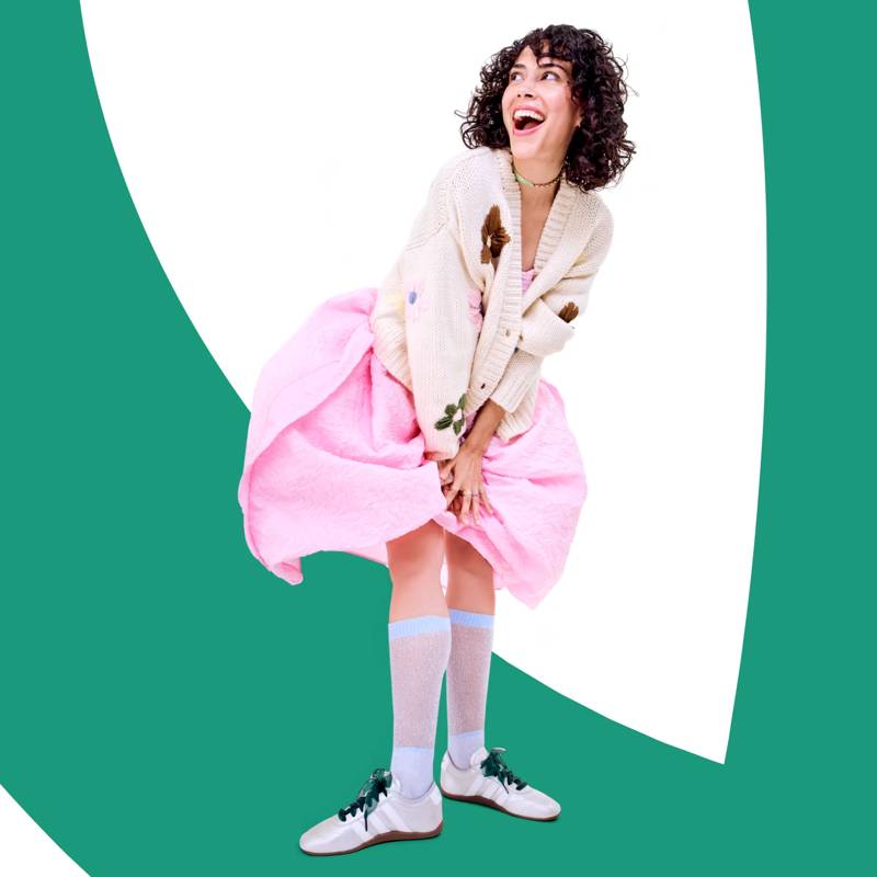 Model wearing the adidas Grand Court Lo Sneakers with a dress and sweater.