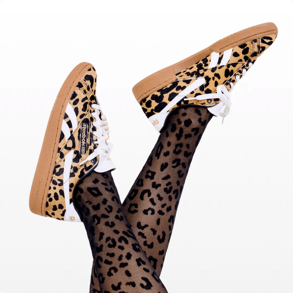 Featuring a model wearing a red reebok sneaker. Click to learn all things sneakers.