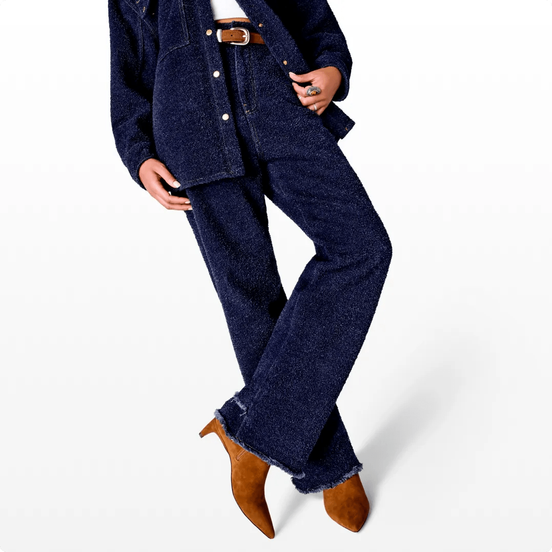 Featuring a model in brown suede boots and denim outfit.
