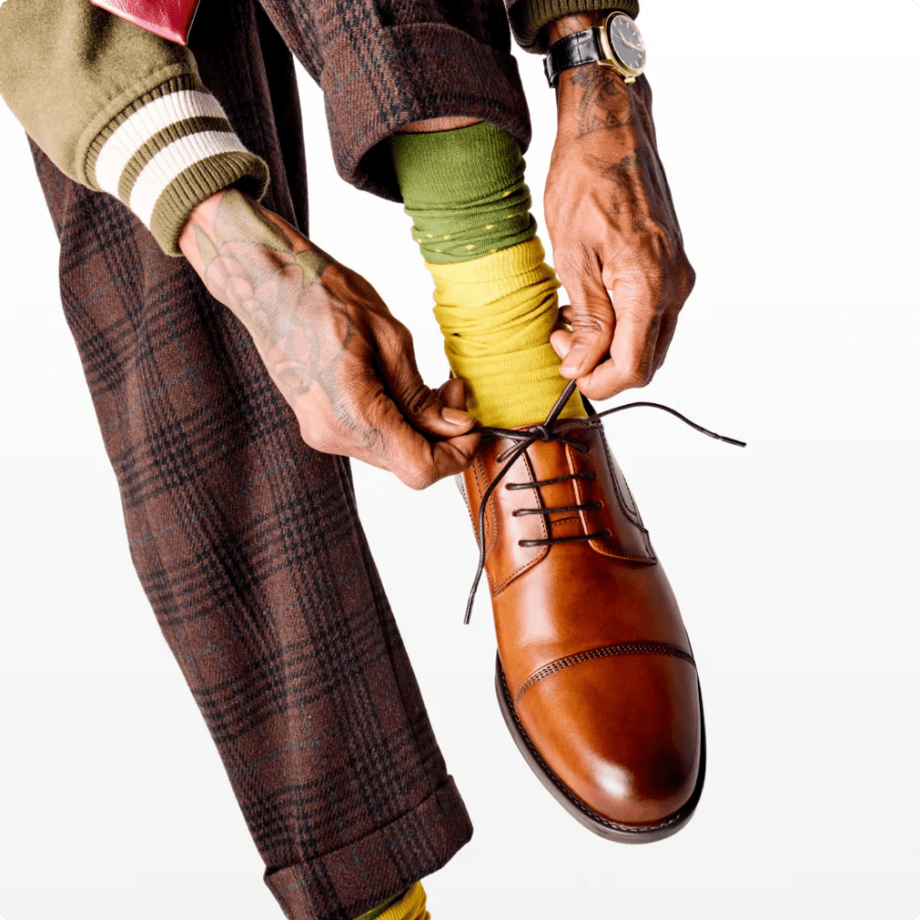 Featuring a model in a men's dress shoe