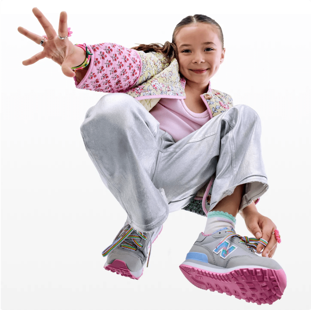 Featuring a model in kids pink and blue New Balance Sneakers.