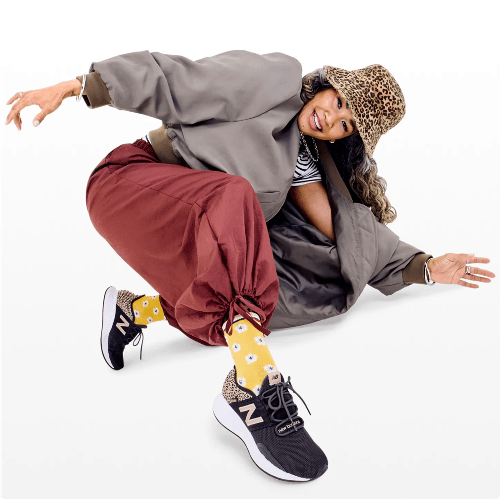 Featuring a model in New Balance walking shoes.