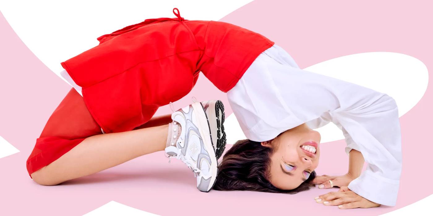 Woman doing a back bend wearing new balance sneakers 596891.