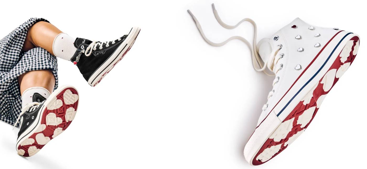 Featuring two pairs of Converse shoes with hearts on the soles.