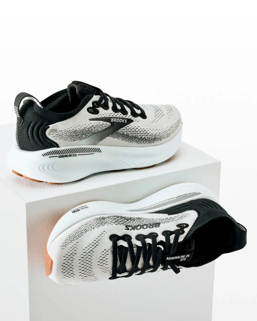 Featuring a pair of black and white Brooks sneakers.