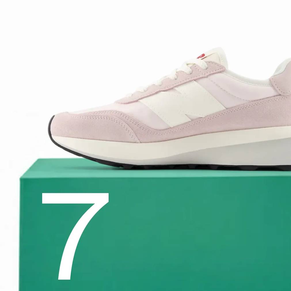 Featuring a women's white and grey New Balance 370 sneaker.