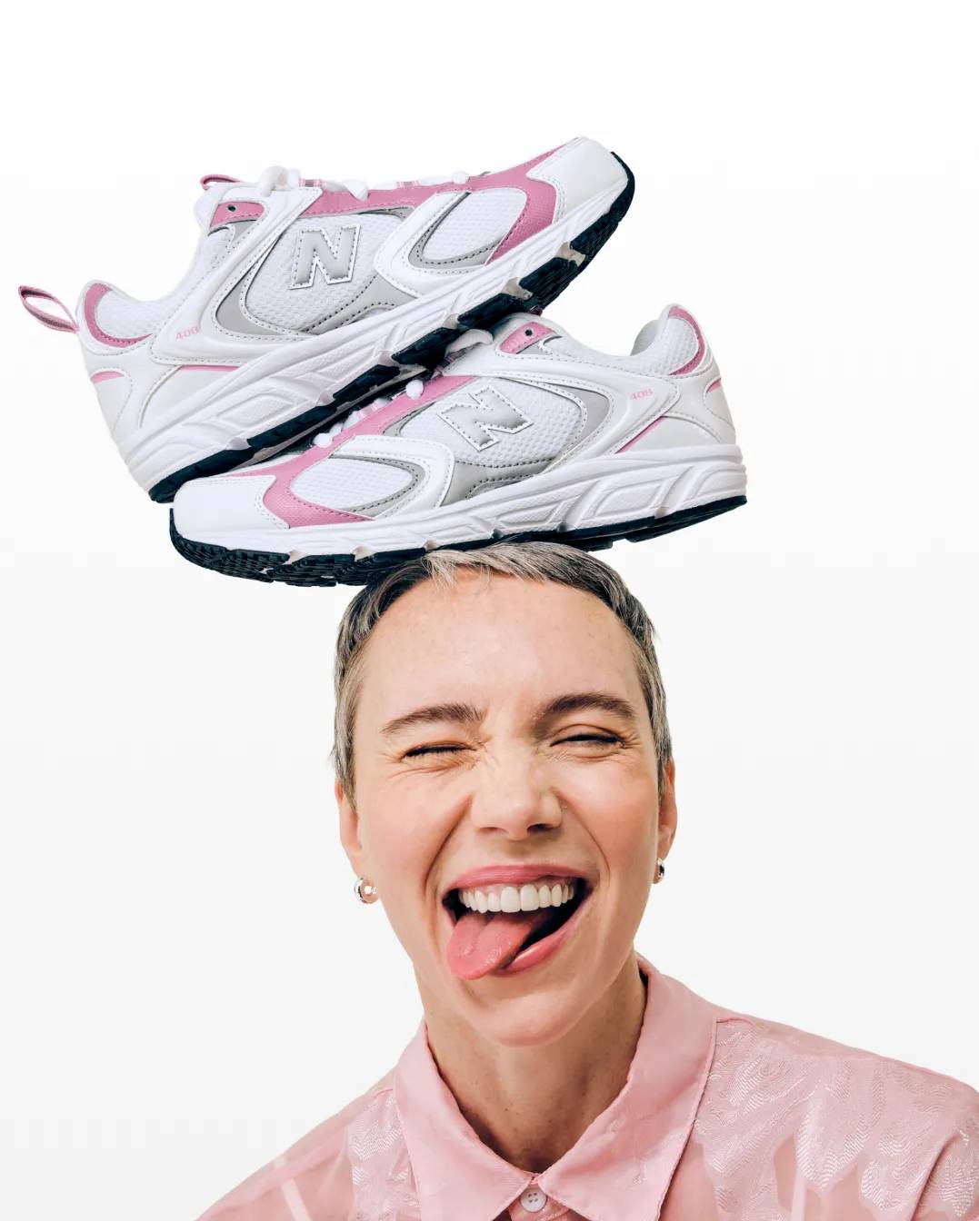 Featuring a woman with New Balance sneakers stacked on her head.