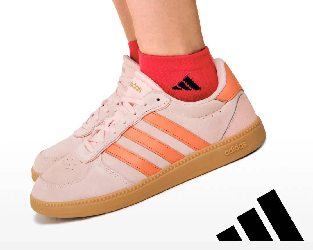 Featuring a pair of bright orange Adidas sneakers.