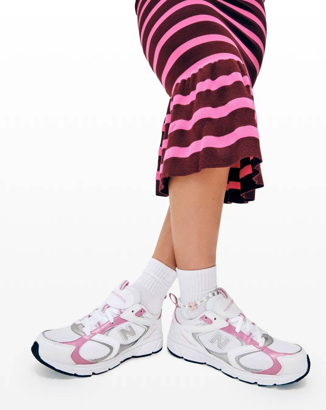 Featuring a skirt and New balance Sneakers