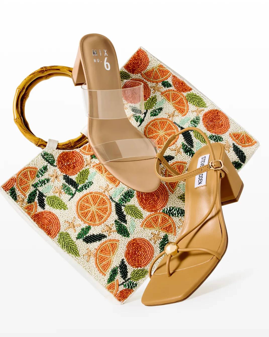 Featuring two block heels and a colorful handbag.