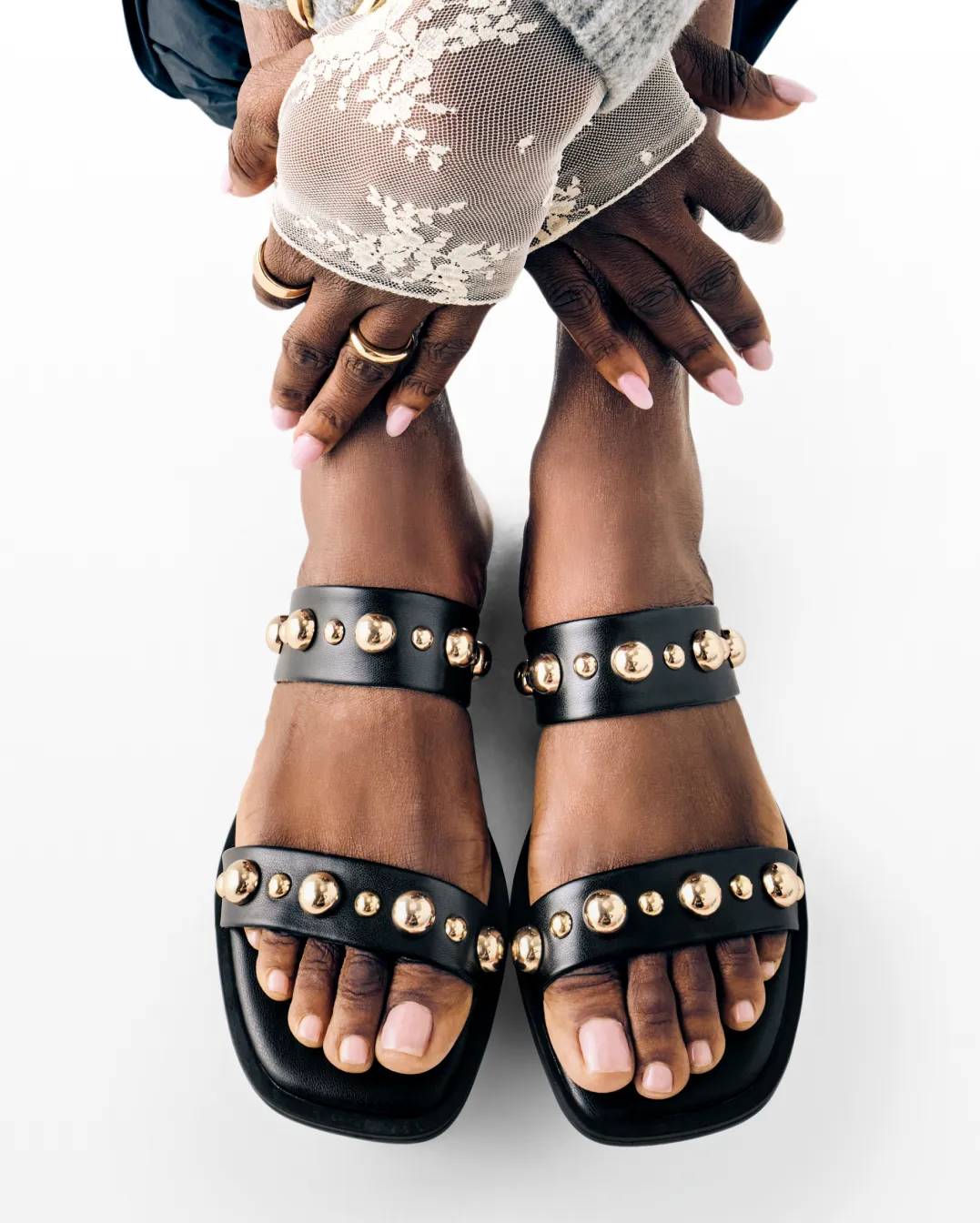 Featuring sandals with hardware details.