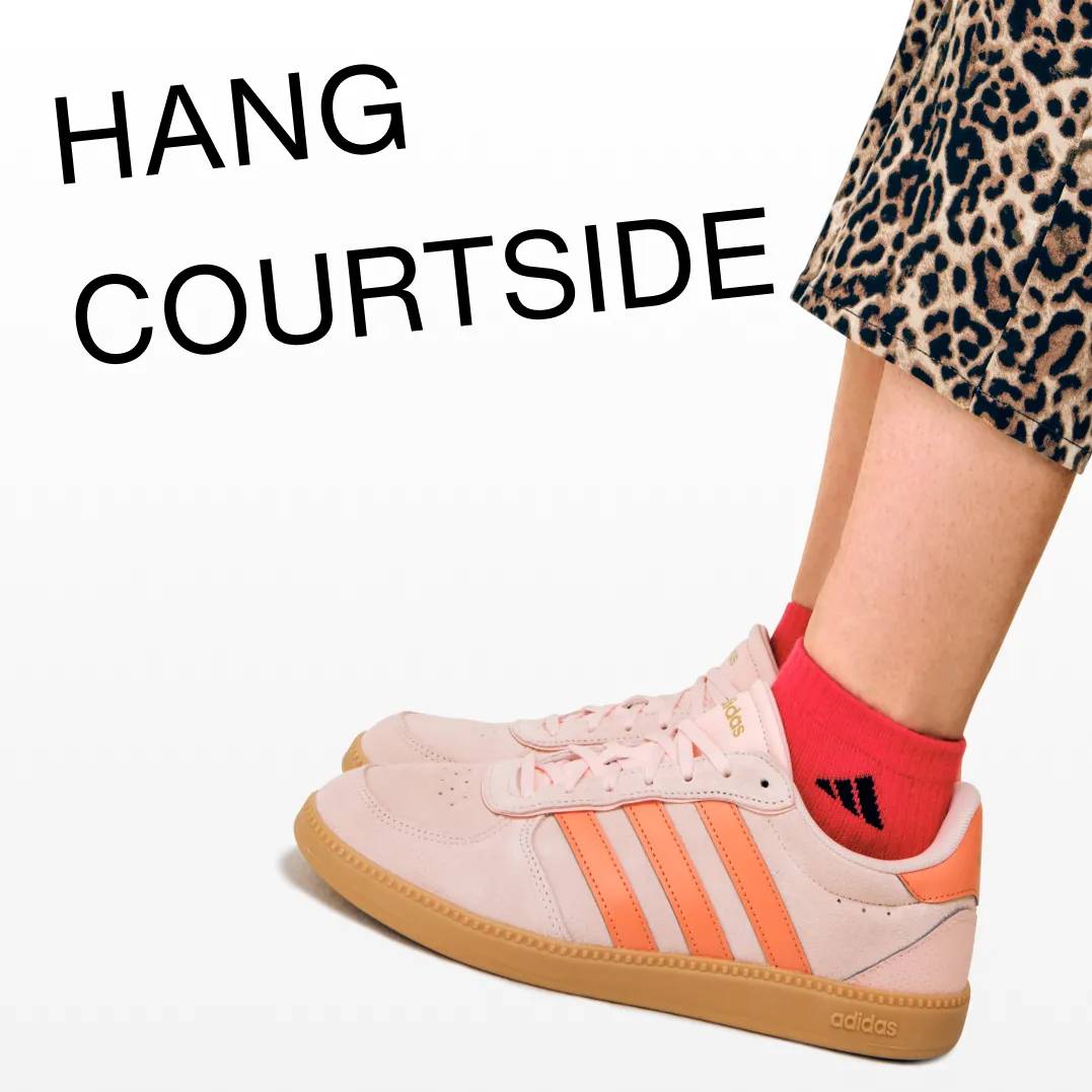 Featuring an orange adidas court sneaker.