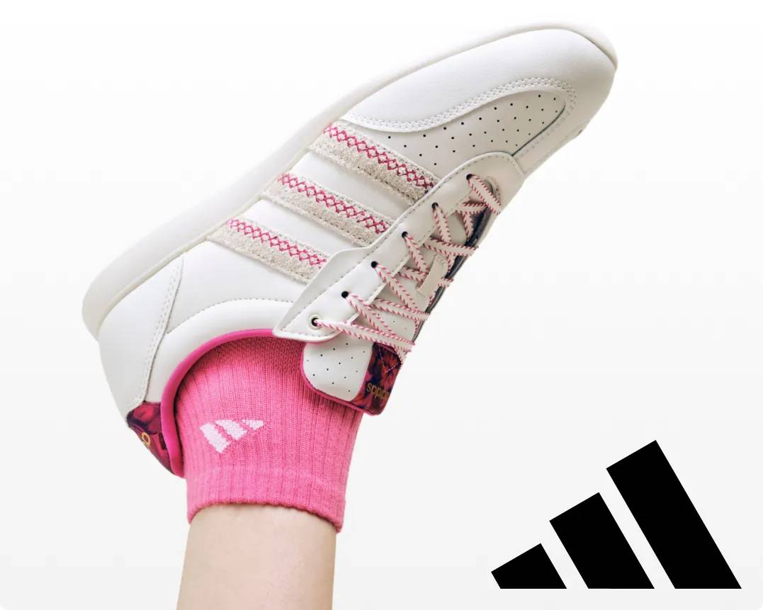 Featuring a pink and white Adidas sneaker.