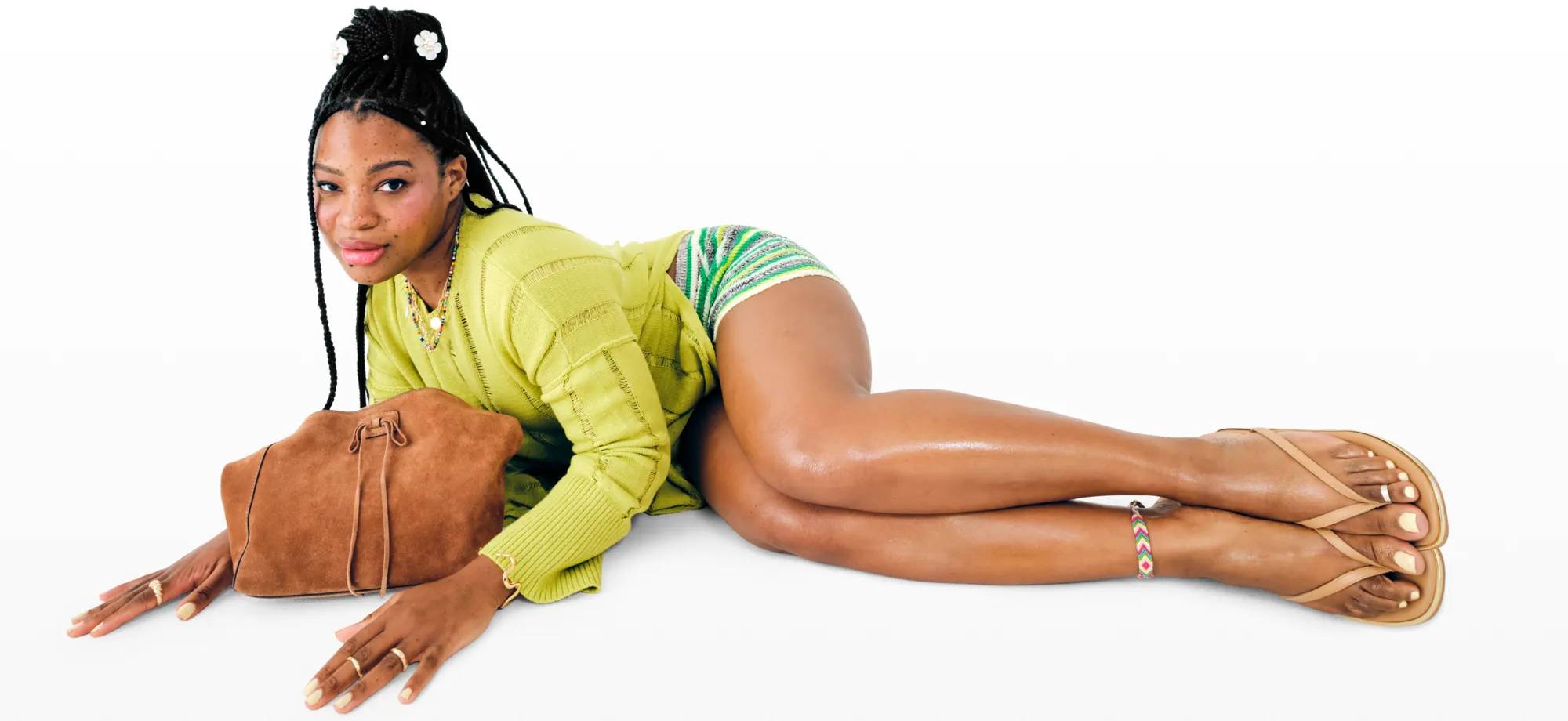 Women wearing a a bright green summer outfit paired with minimal flip-flops.
