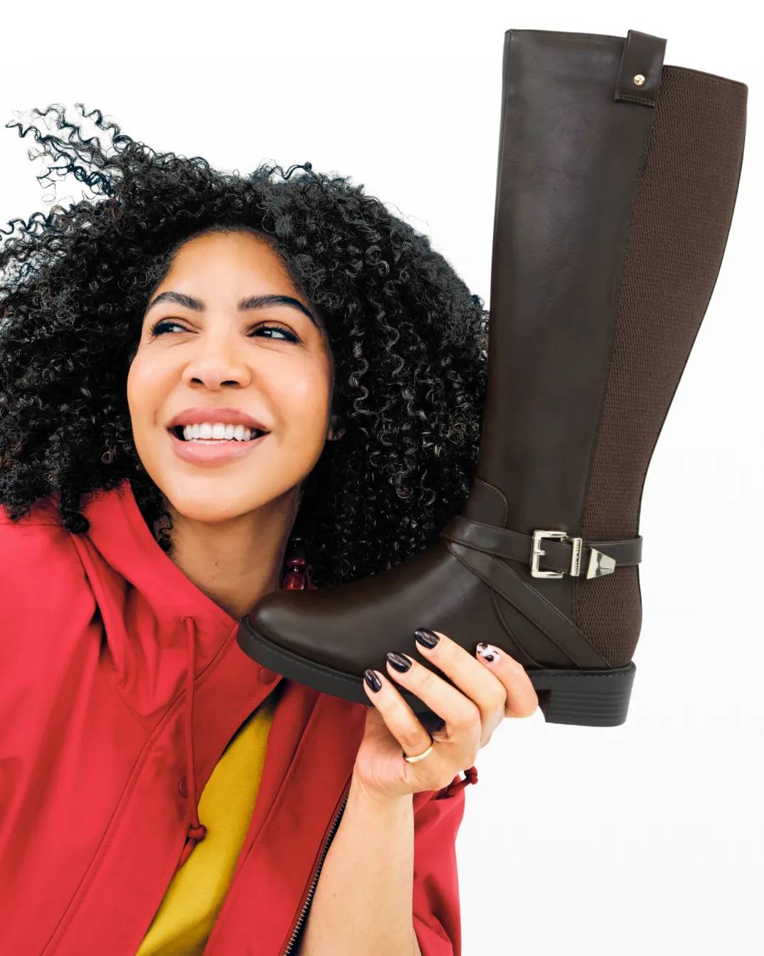 Featuring a model holding a leather boot.