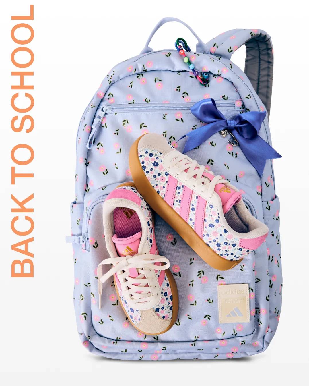 Featuring a backpack and pink adidas sneakers.