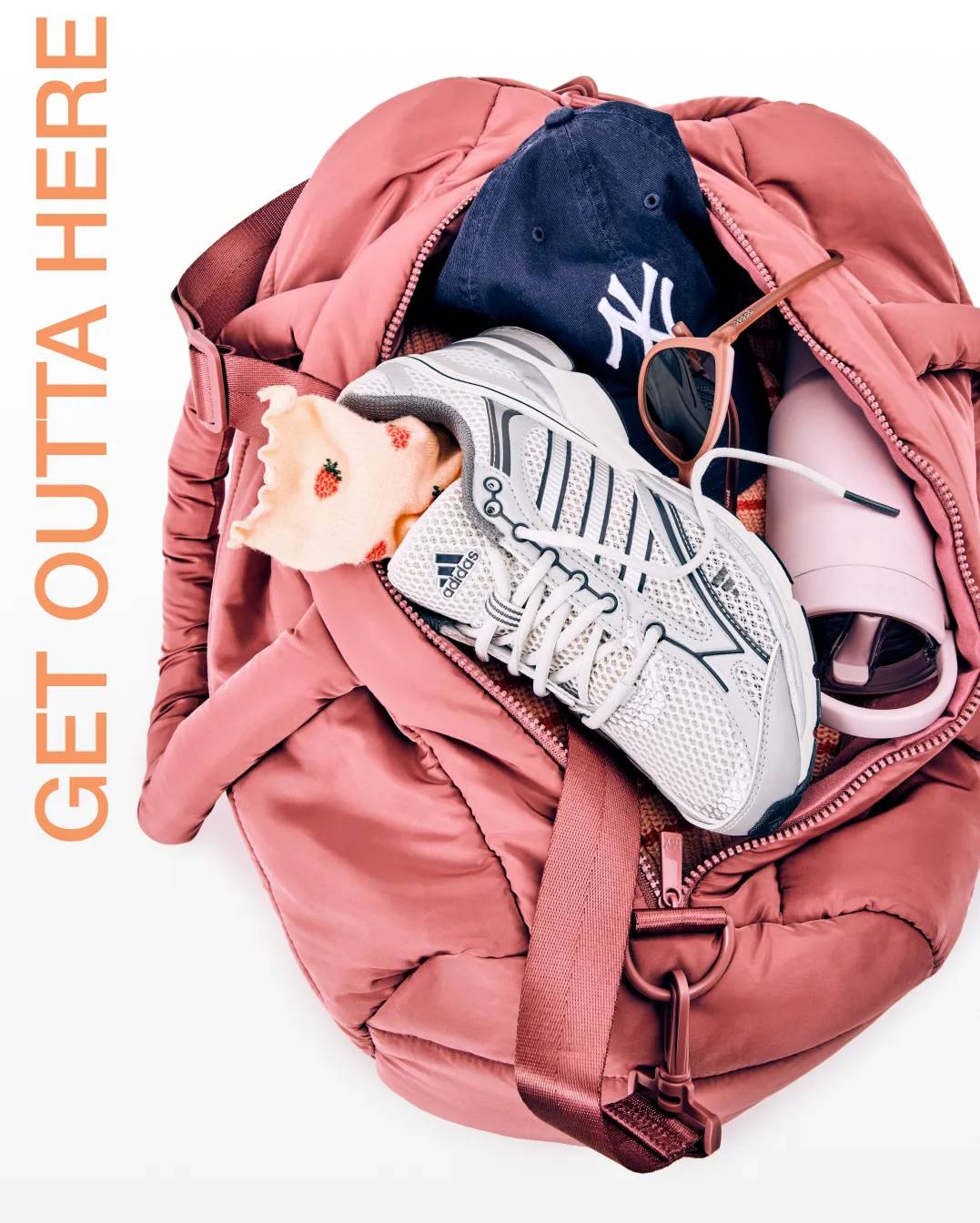 Featuring a pink travel bag stuffed with sneakers, and travel accessories.