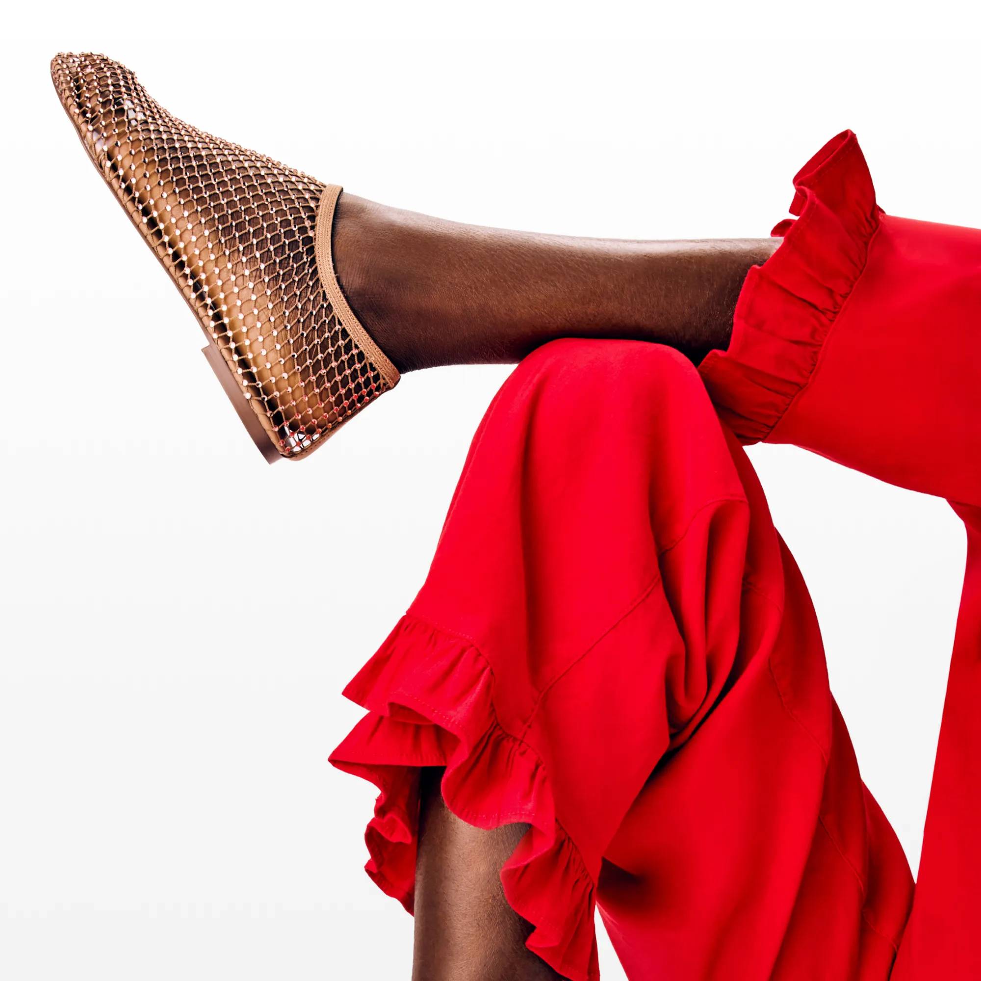 Featuring a woman wearing red pants and a flat.