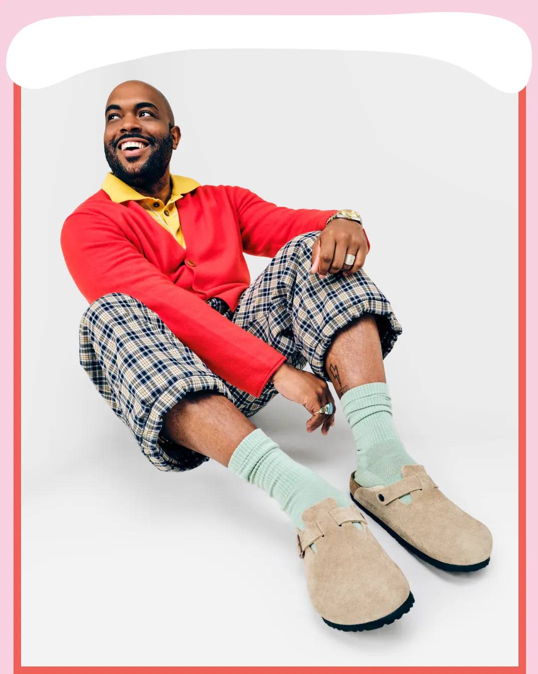 Featuring a man wearing a pair of Birkenstock slides.