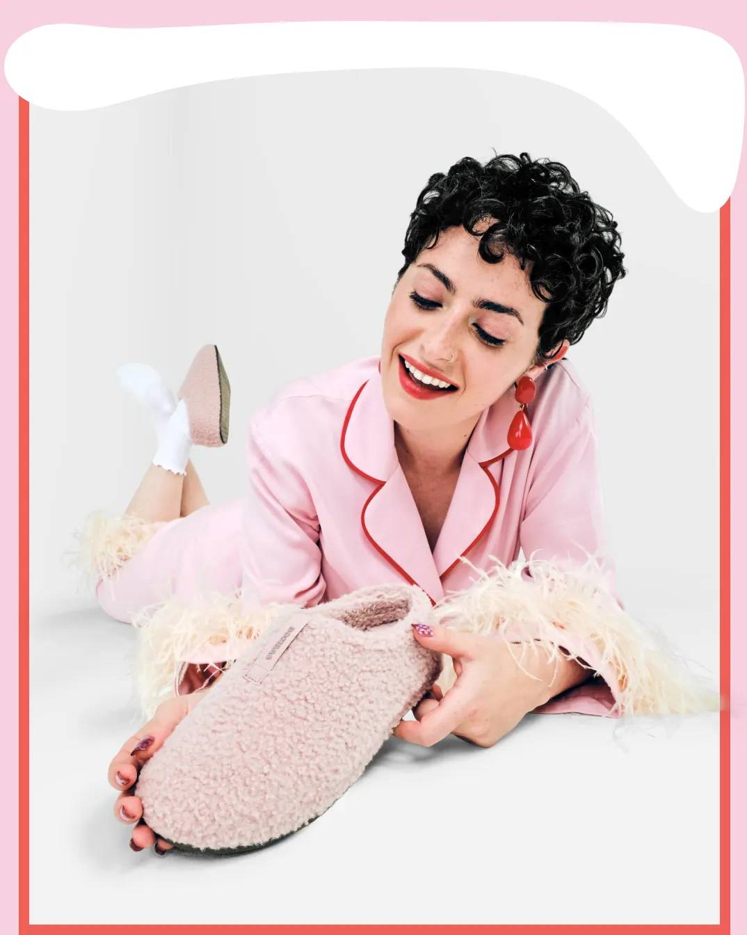 Featuring a model holding Bombas slippers.