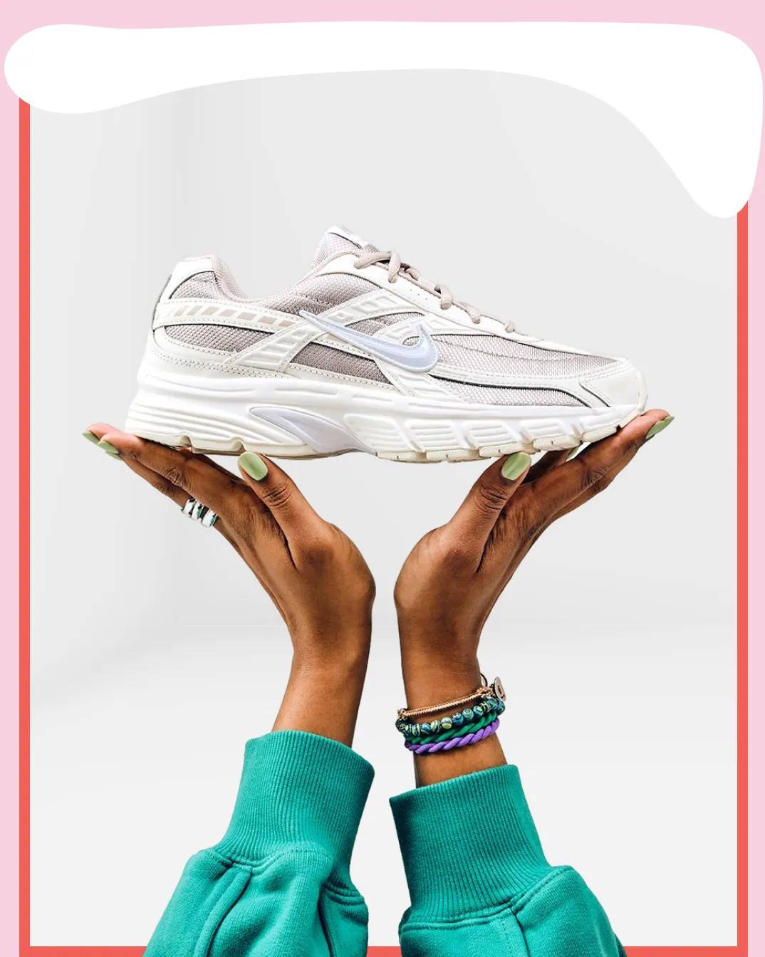 Featuring a model holding Nike sneakers