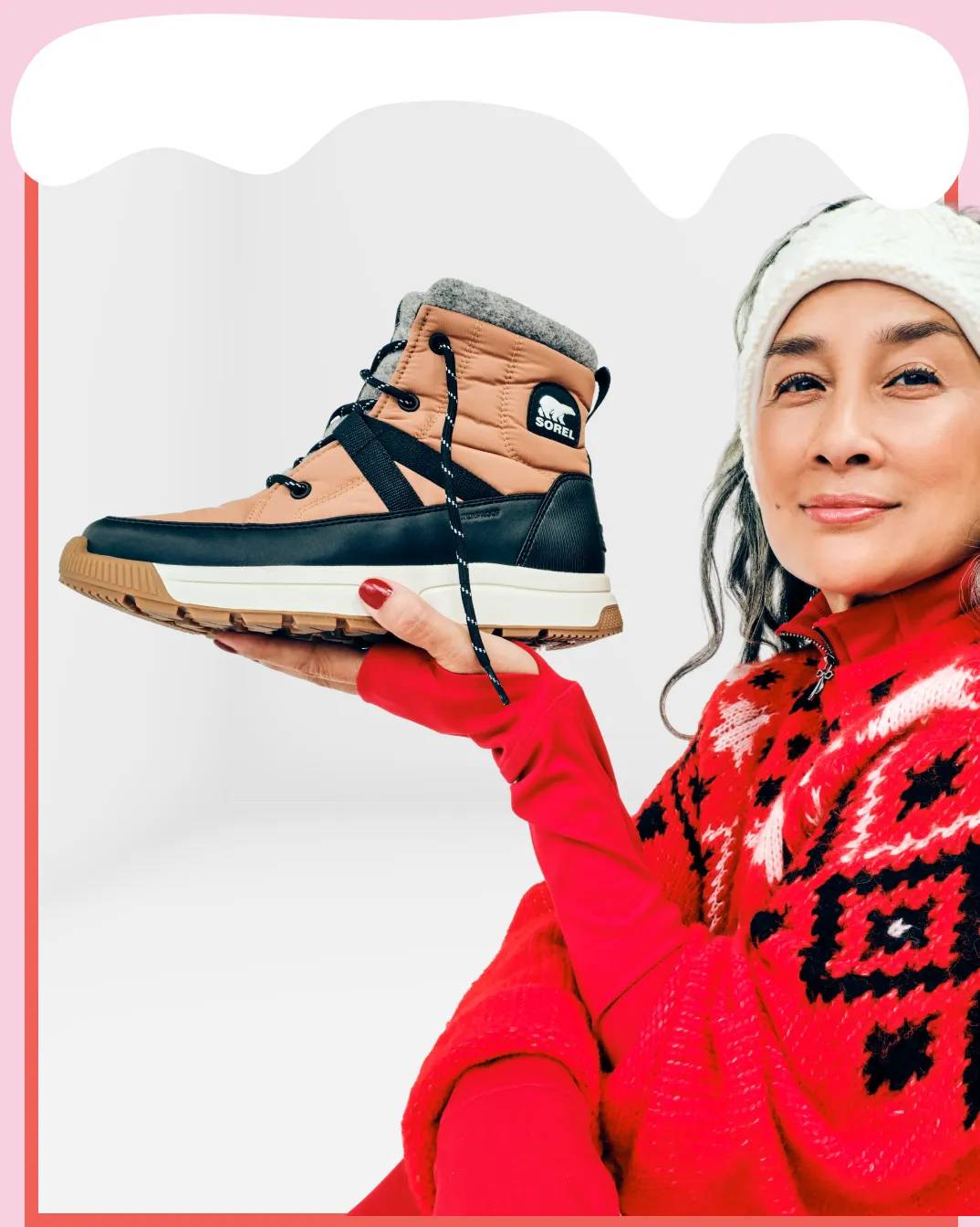 Featuring a model holding a winter boot from SOREL.
