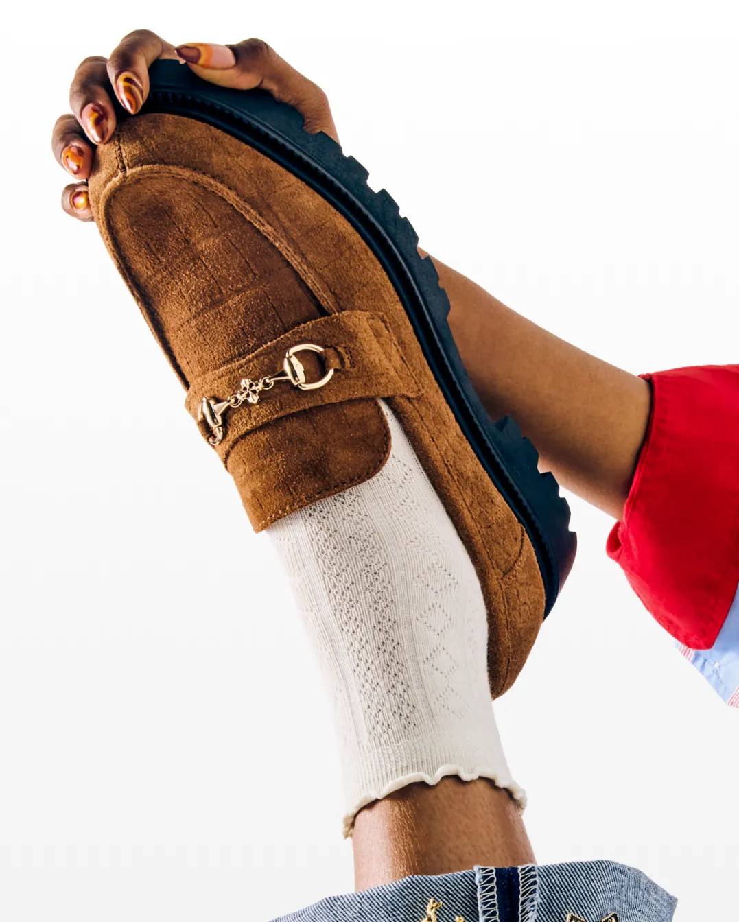 Featuring a pair of brown loafers.