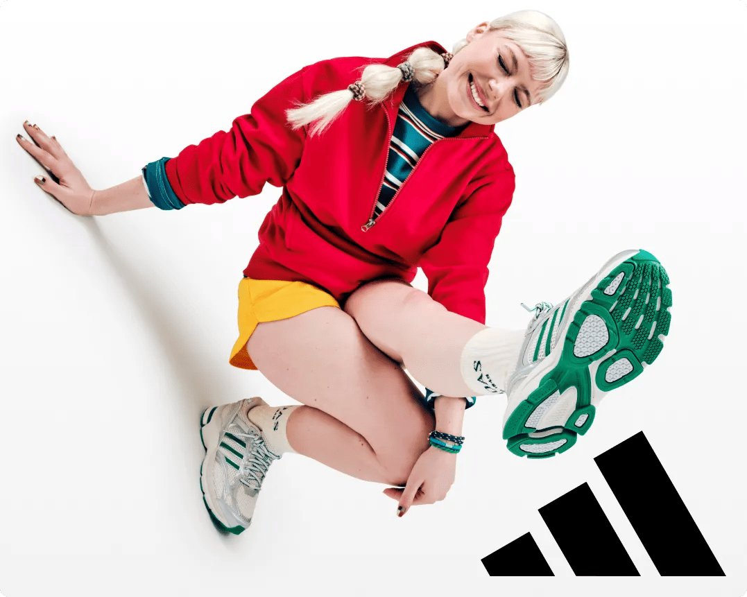 Featuring a girl wearing white and green adidas sneakers.