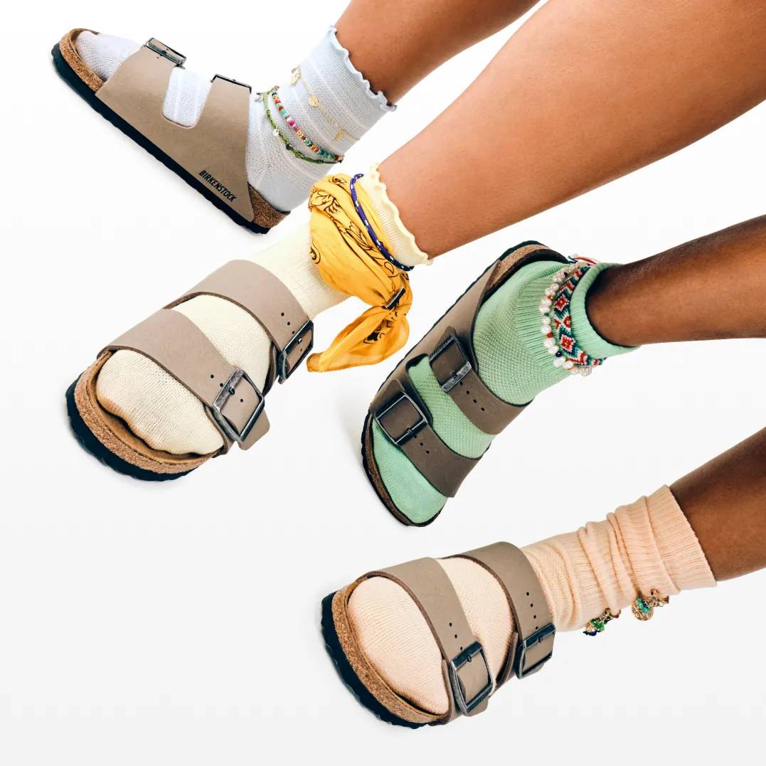 Featuring a model in green and white Nike Court Vision Sneakers.