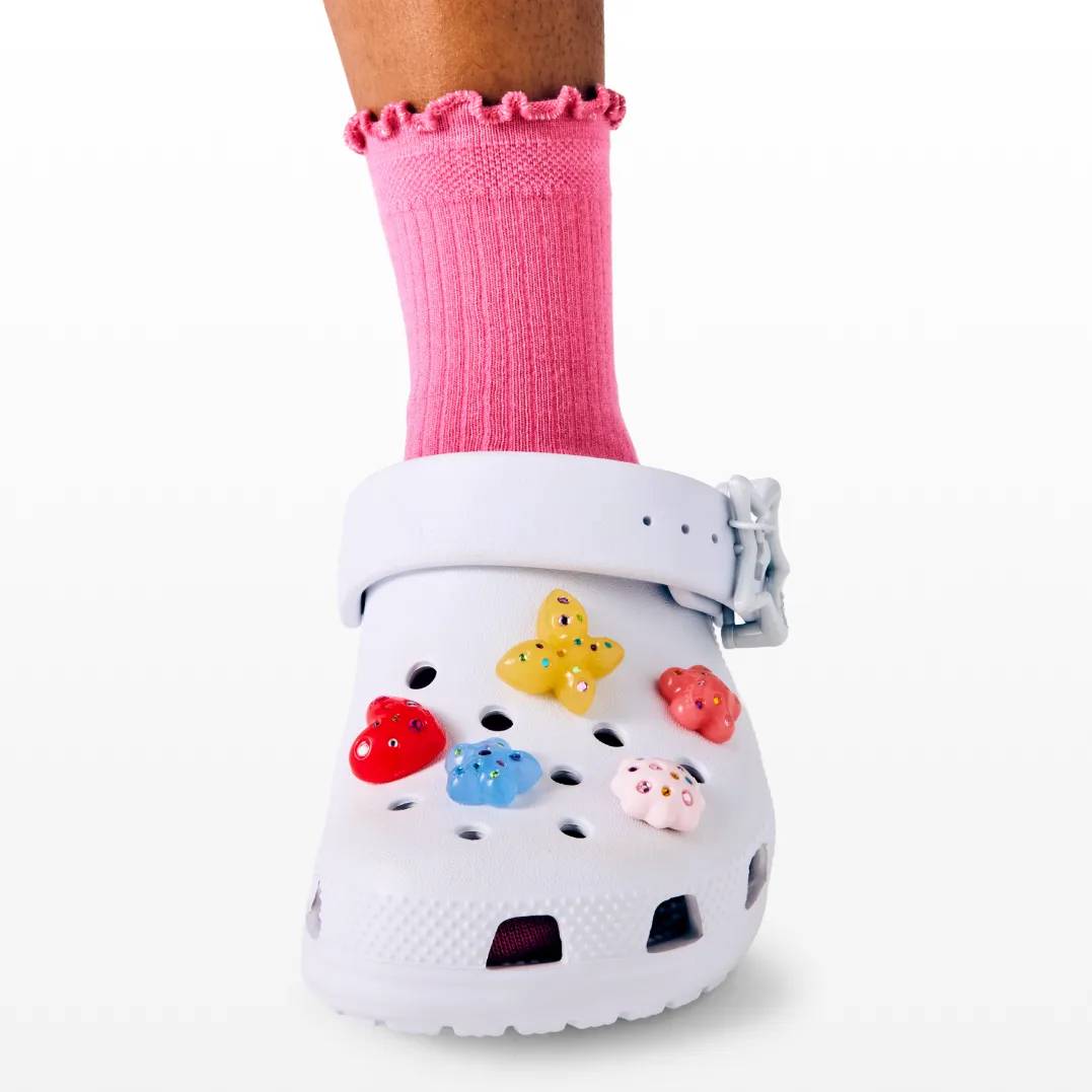 Featuring a model in kids pink and blue New Balance Sneakers.