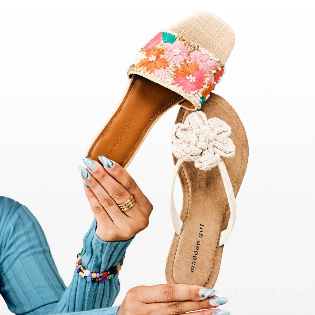 Featuring an assortment of black and grey slide sandals.
