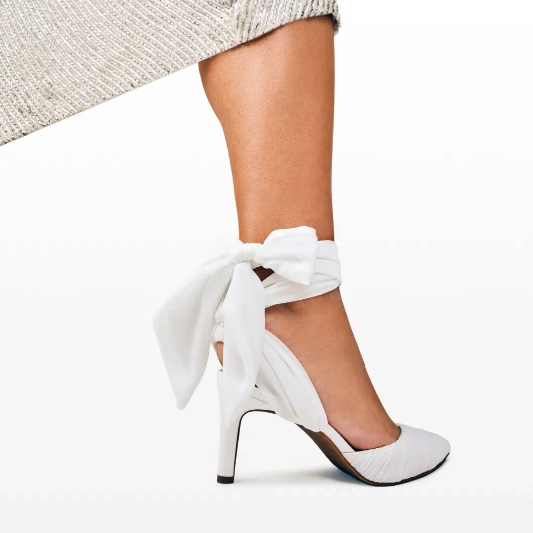 Featuring a bridal heel with a bow detail. Click to read more about what shoes to wear to a formal wedding.
