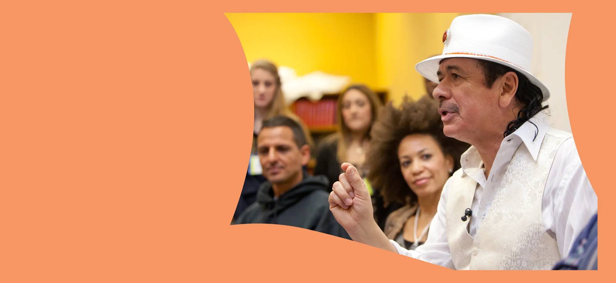 Orange background with a picture of Carlos Santana giving a message to a group of people.