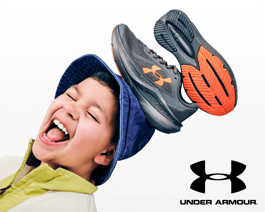 Featuring a kid wearing a bucket hat with grey and orange sneakers.