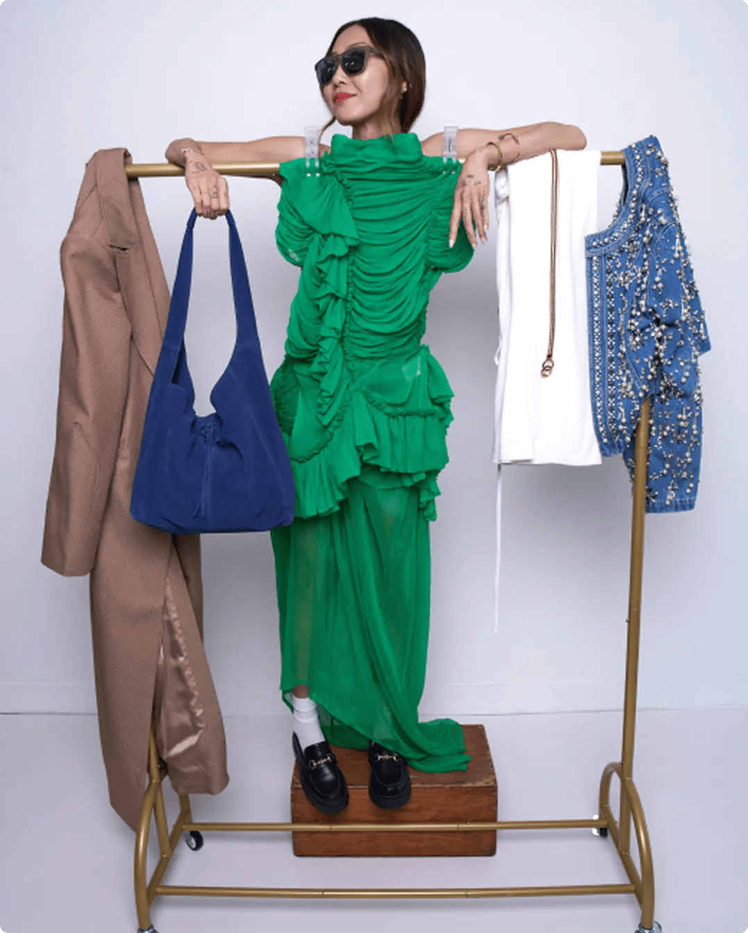 Featuring Emily Men standing on a clothing rack with clothes and shoes.